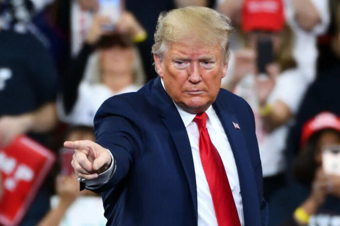 1585235179 Man in suit pointing at crowded event