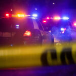 Border Clashes Ignite Fear of War Police cars with flashing lights behind caution tape