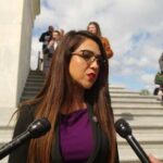 Female politician speaking to reporters outside