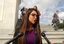 Female politician speaking to reporters outside