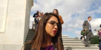 Female politician speaking to reporters outside