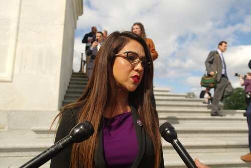 Female politician speaking to reporters outside