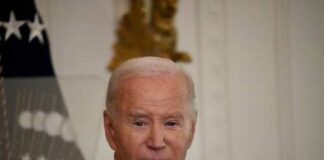 A political figure speaking at a formal event in the White House