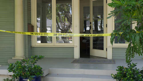 shutterstock_638801206.jpg A front porch with caution tape indicating a crime scene