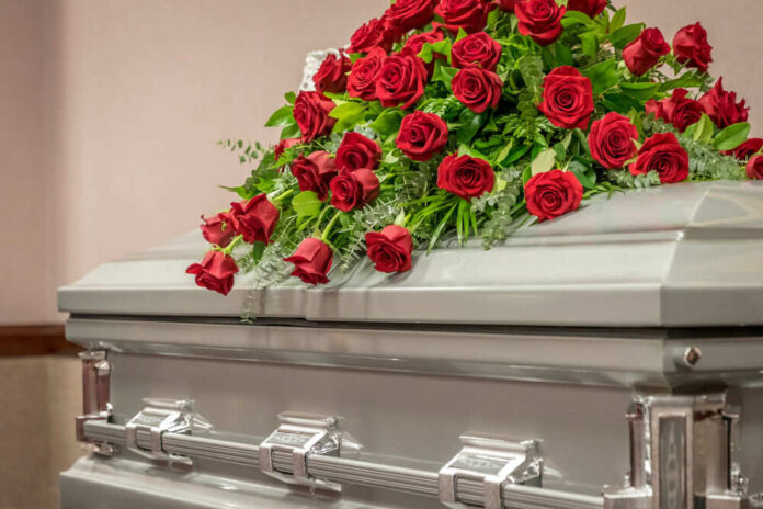 Casket with red roses on top