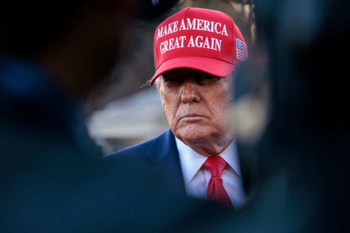 Person in red hat and suit looking serious