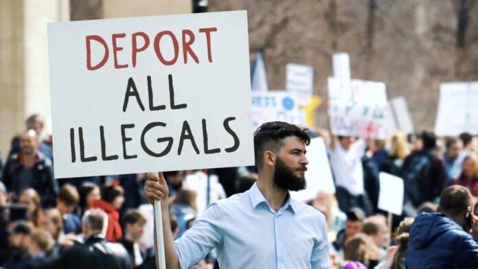 Person holding sign in a crowded protest