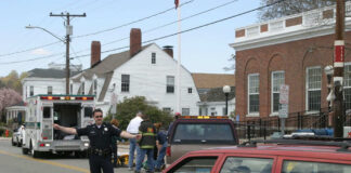 Police officer directing traffic near ambulance scene