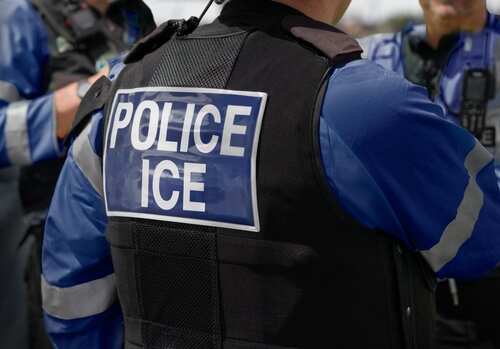 shutterstock_2615419741 (10).jpg Close-up of a police officers uniform with POLICE ICE on the back