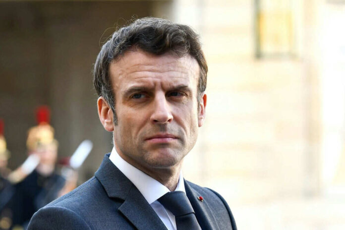 Man in suit looking serious with guards behind him