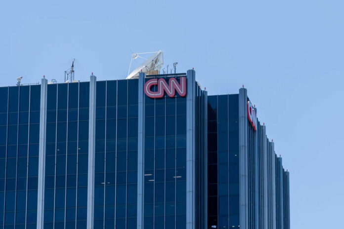 Glass building with CNN logo on rooftop
