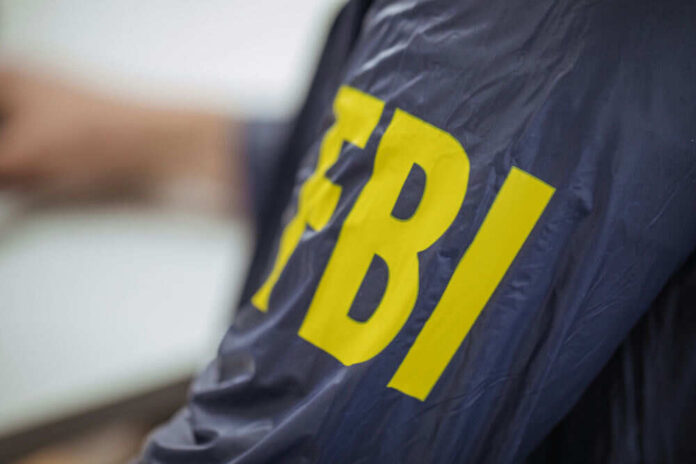 Navy jacket with yellow FBI lettering visible