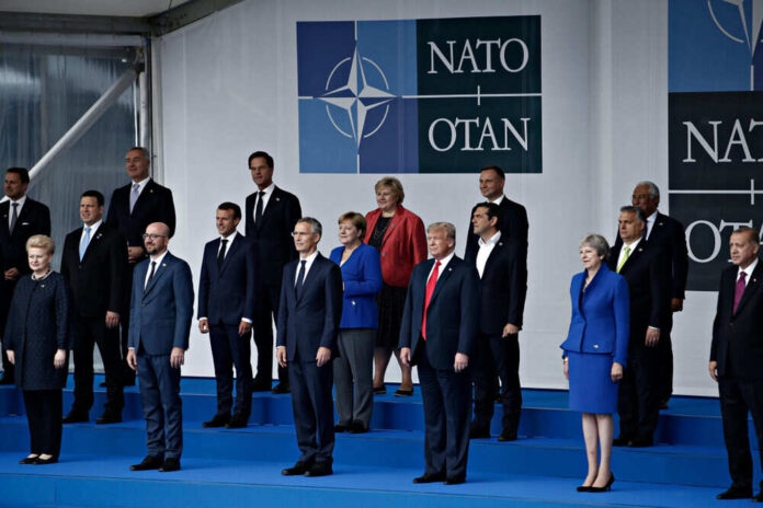 Leaders standing on stage at NATO summit event