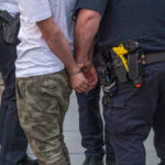 FBI Bombshell: Capitol Case Blunder Revealed Person handcuffed by police on the street