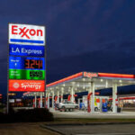 Exxon gas station with fuel price sign illuminated
