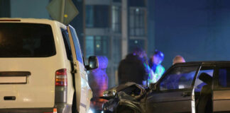 Two cars crashed at night with people nearby