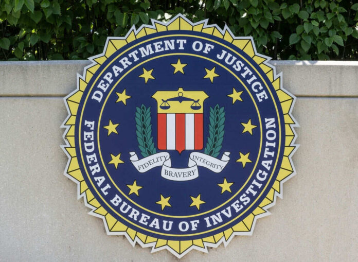 FBI seal on stone wall with foliage background