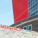 Unseen Health Struggle: Supermodel’s Shocking Surgery Emergency sign outside modern building with windows