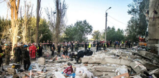 Rescue workers clearing debris after building collapse