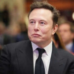 EU Bureaucrats SLAM Musk’s X With First Mega Fine Man in suit at an event looking sideways