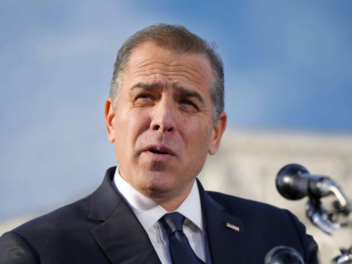 Man speaking outside with microphones in foreground