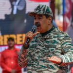 Trump’s Venezuela Strategy: A Hidden Agenda? Man in camouflage uniform speaking at event outdoors