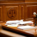 Hollywood Star’s Shocking Fall From Grace Courtroom desk with papers and microphone visible
