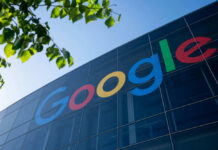 Google logo on glass building exterior with leaves